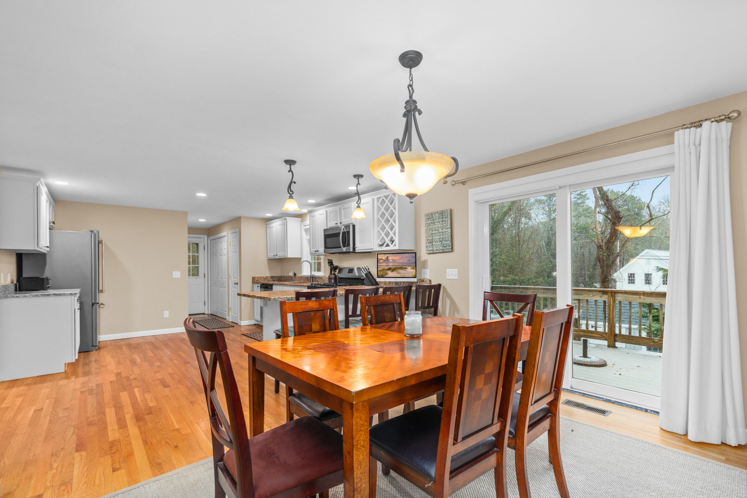 5 Baker Road Wellfleet, MA 02667 - Photo 10 of 30 a dining room with furniture a chandelier and wooden floor
