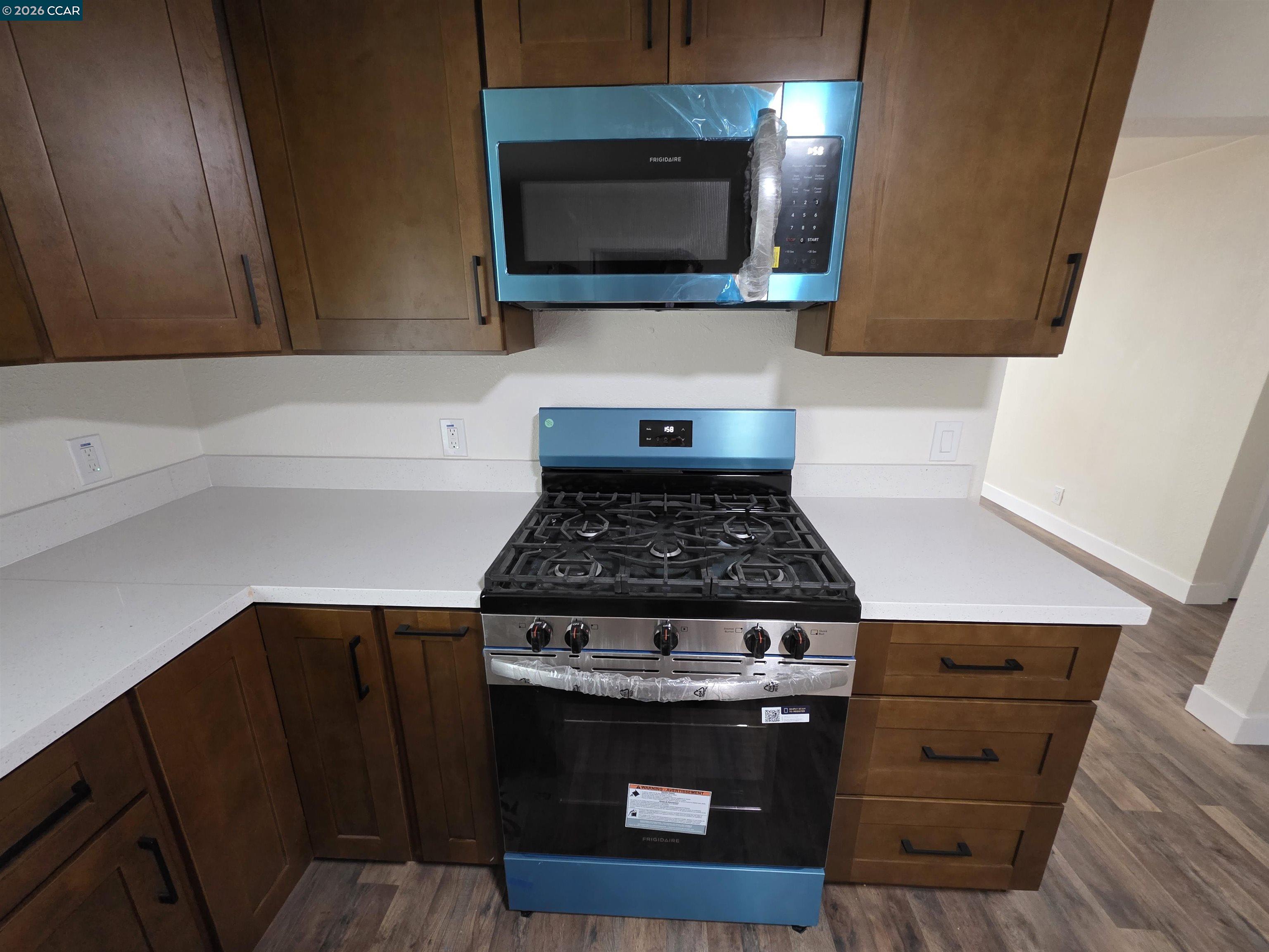 139 Ambrose Avenue, Unit A Bay Point, CA 94565 - Photo 8 of 13 a kitchen with a stove and a microwave