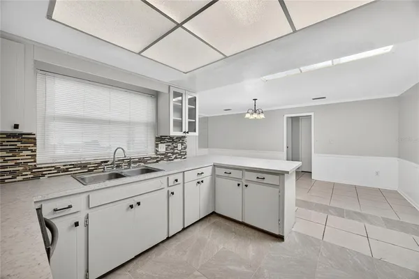a kitchen with a sink stove and cabinets