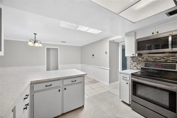 a kitchen with a sink and stainless steel appliances