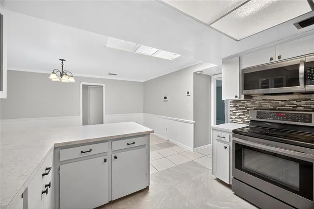 a kitchen with a sink and stainless steel appliances