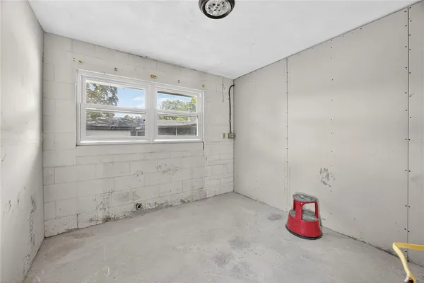 an empty room with closet and a hallway