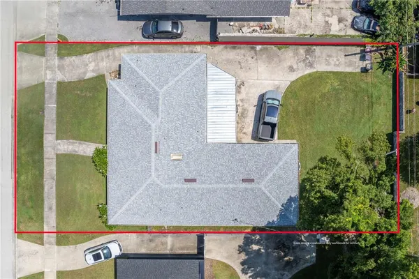 an aerial view of a house with a yard