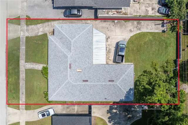 an aerial view of a house with a yard