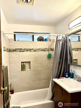 a bathroom with a tub sink and a shower