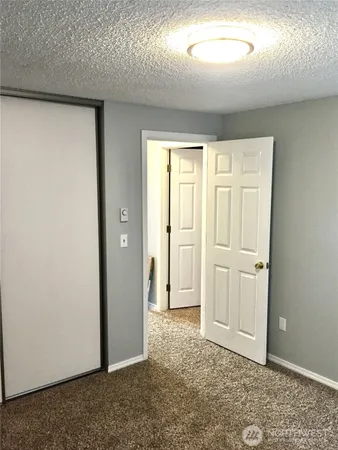 an empty room with closet area