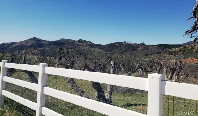 a view of a wooden fence and a mountain view