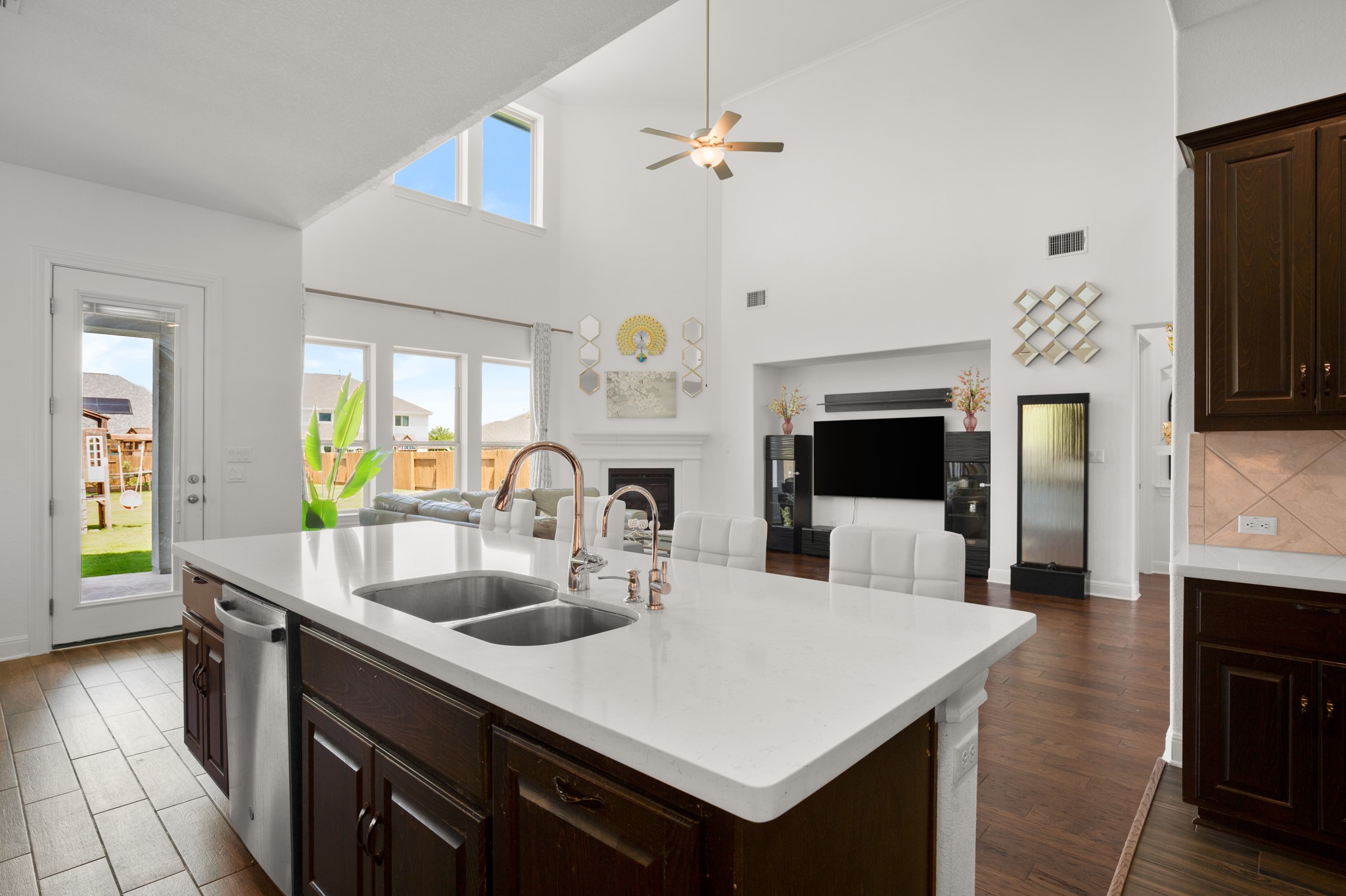 2817 Gatlin Cove Leander, TX 78641 - Photo 14 of 40 Easily stay connected while whipping up your favorite culinary delights and enjoy beautiful views from the wall of windows lining the backside of the home.