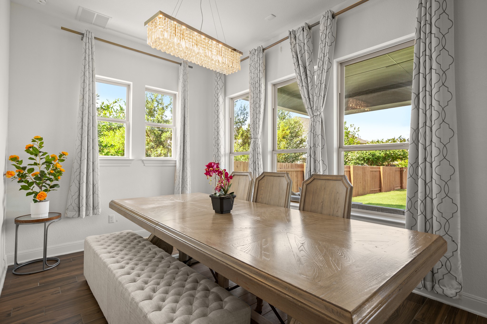 2817 Gatlin Cove Leander, TX 78641 - Photo 15 of 40 A spacious and sunlit dining area off the kitchen provides ample space for a large dining table under a chic chandelier.