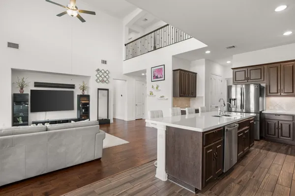 a living room with furniture and kitchen view