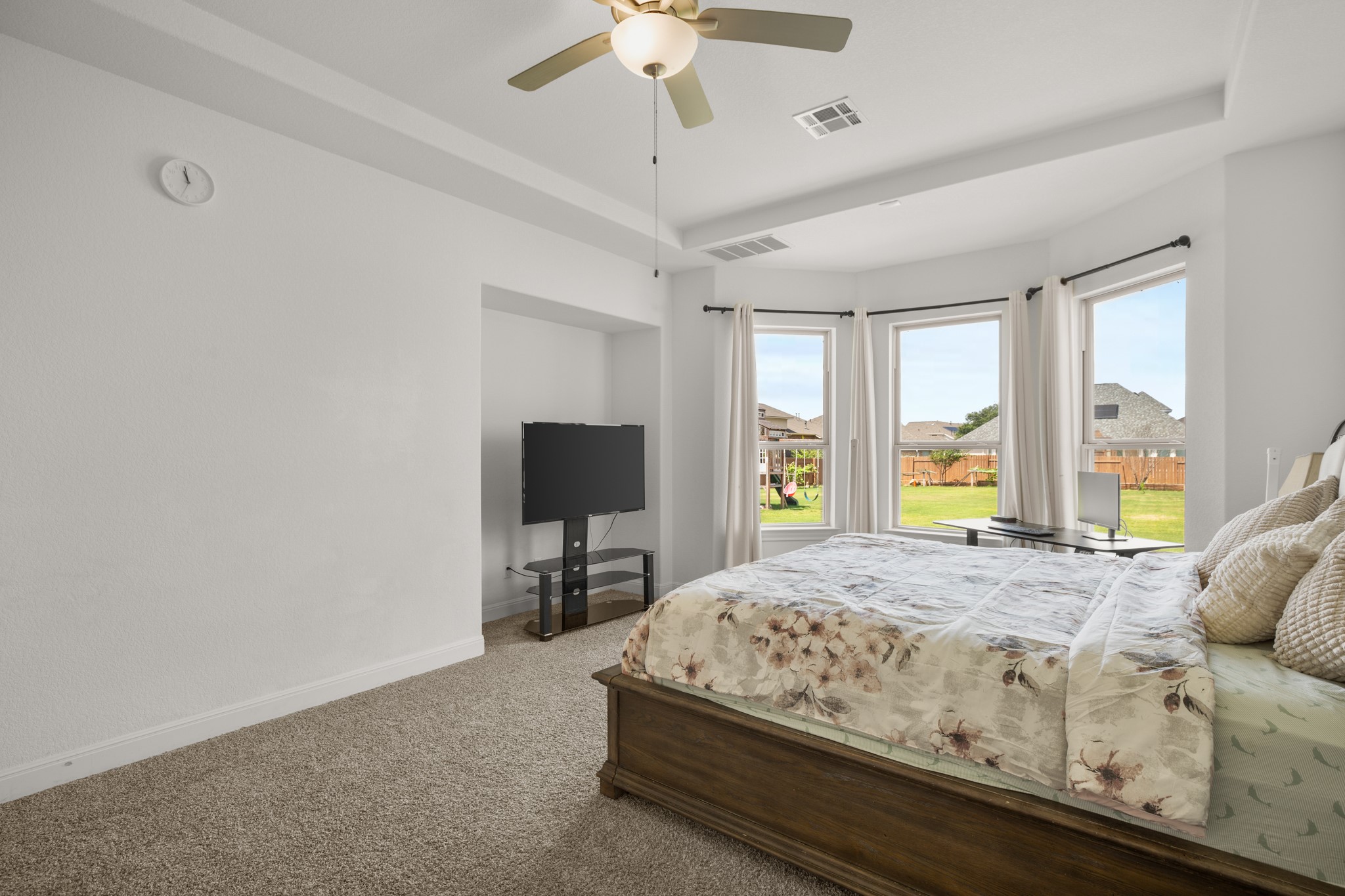 2817 Gatlin Cove Leander, TX 78641 - Photo 19 of 40 The secluded main floor primary suite is a tranquil retreat with lovely bay windows, backyard views, tray ceilings, and an entertainment center nice.