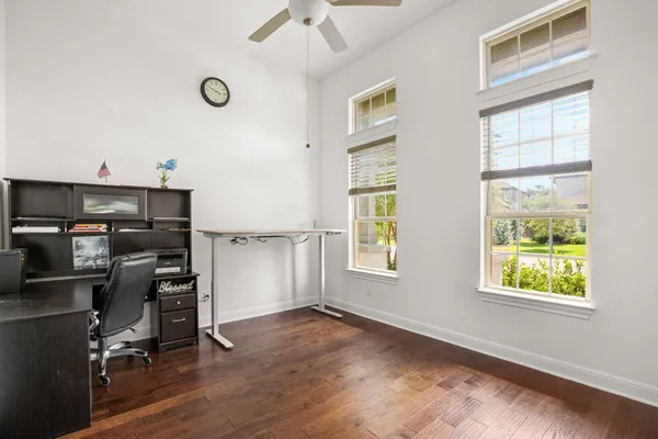 a living room with furniture and wooden floor