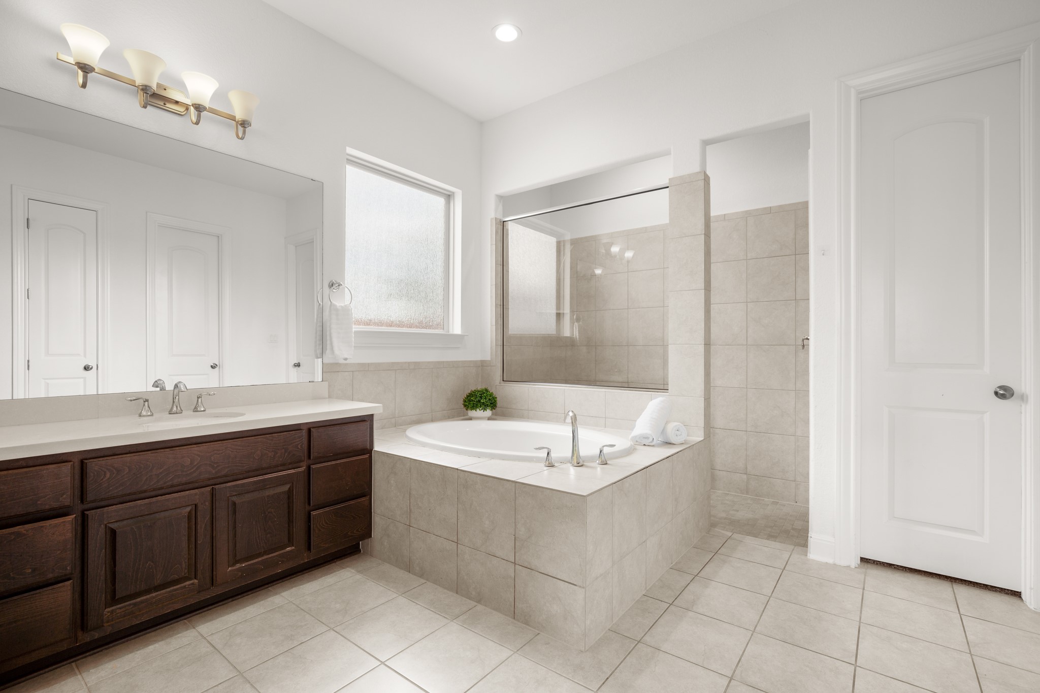 2817 Gatlin Cove Leander, TX 78641 - Photo 21 of 40 Enjoy a relaxing built-in soaking tub under a privacy window and a separate walk-in shower.