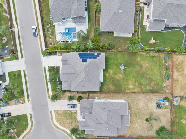 an aerial view of residential houses with outdoor space