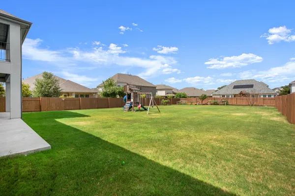 a kitchen with stainless steel appliances kitchen island granite countertop a refrigerator and a stove top oven
