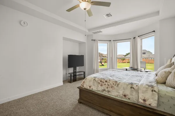 a very nice looking room with wooden floor and windows