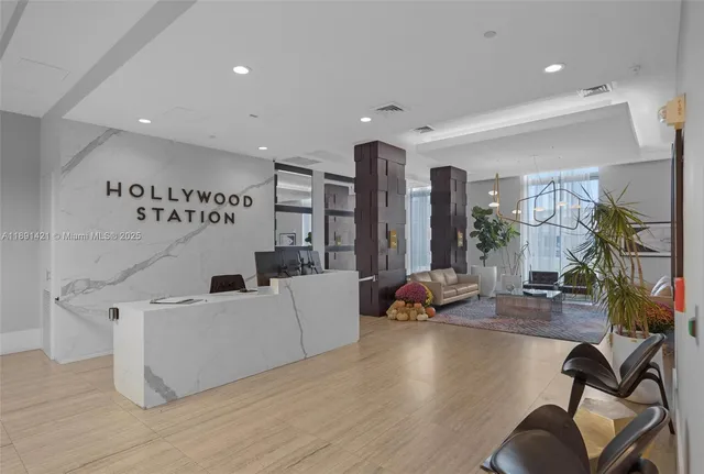 a living room with furniture and large windows