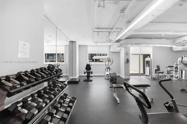 a room with gym equipment and a large window