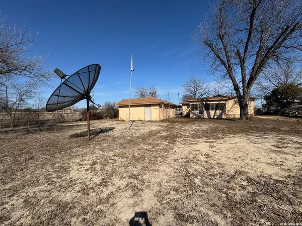 a view of a backyard with table and chairs and a fire pit