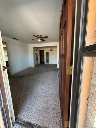 a view of a livingroom with wooden floor and staircase