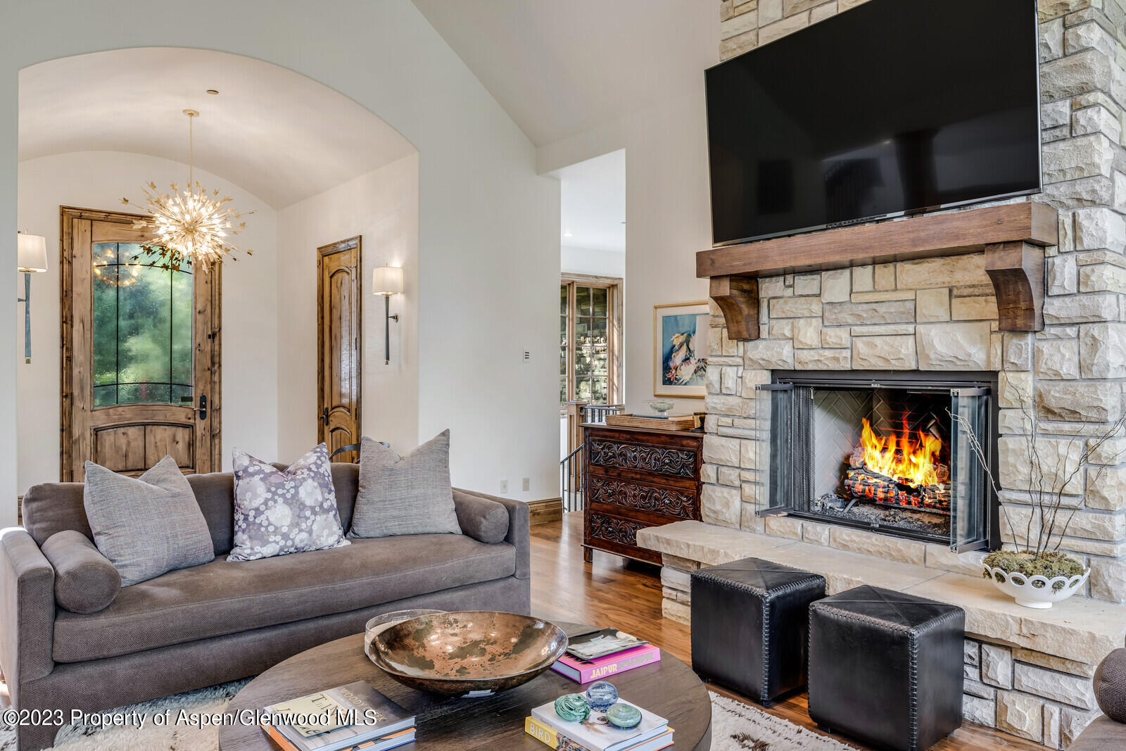 70 River Bend Road Snowmass, CO 81654 - Photo 11 of 70 a living room with furniture a flat screen tv and a fireplace