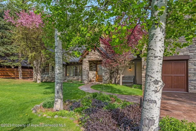 a bedroom with furniture and a chandelier fan