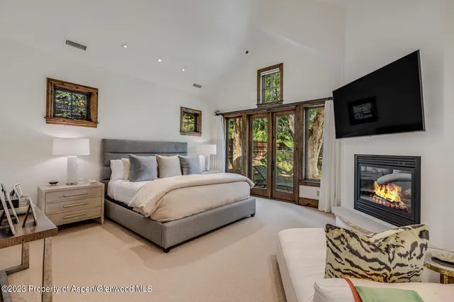 a bedroom with a bed and a flat screen tv