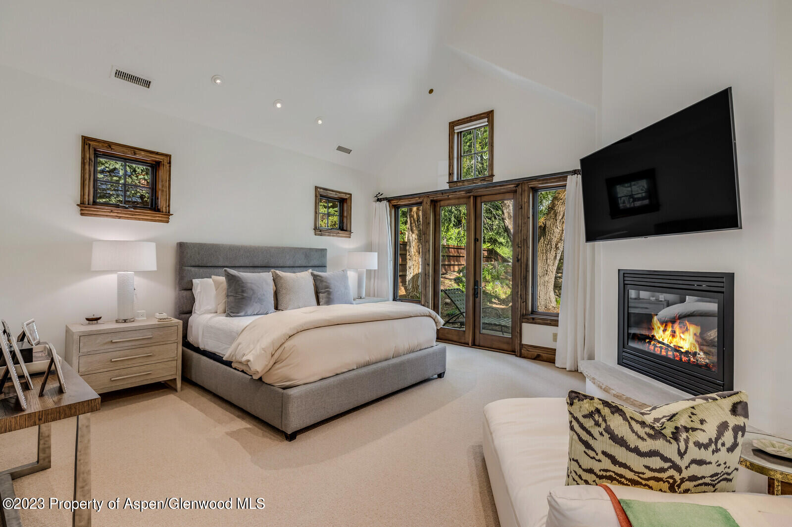 70 River Bend Road Snowmass, CO 81654 - Photo 27 of 70 a spacious bedroom with a bed a flat screen tv and a couch