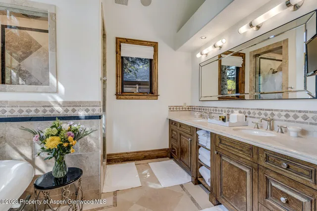 a bathroom with a toilet sink vanity and mirror