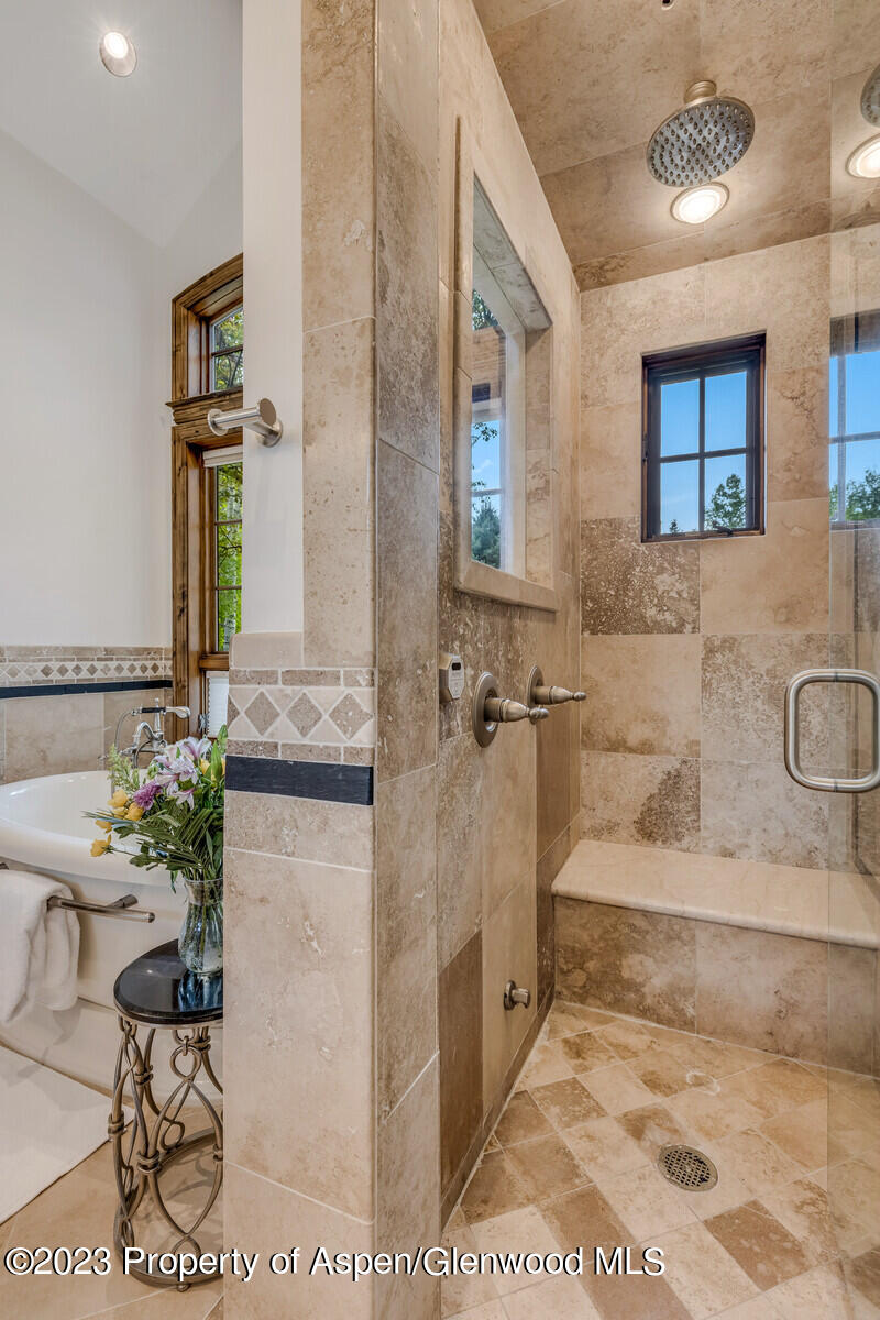 70 River Bend Road Snowmass, CO 81654 - Photo 31 of 70 a bathroom with a tub sink and mirror