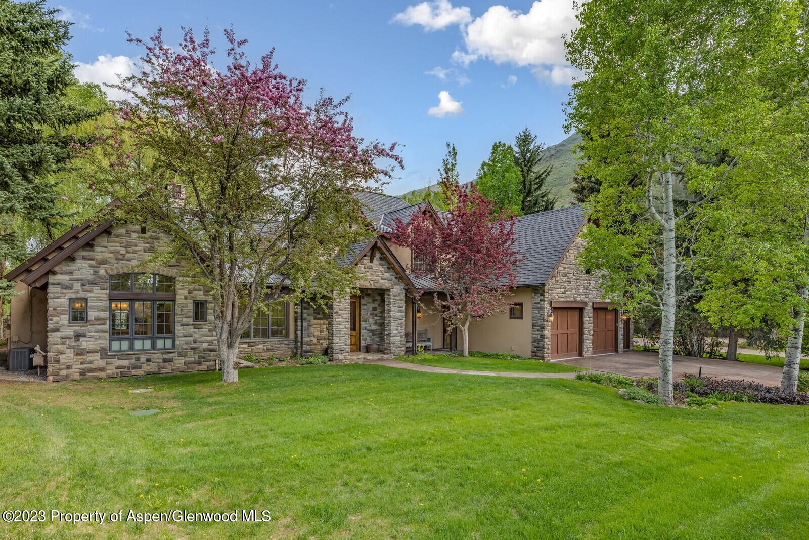 70 River Bend Road Snowmass, CO 81654 - Photo 36 of 70 a view of a house with a big yard and large trees