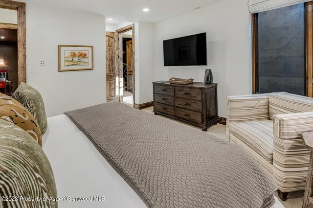 a view of a hallway with wooden floor and stairs