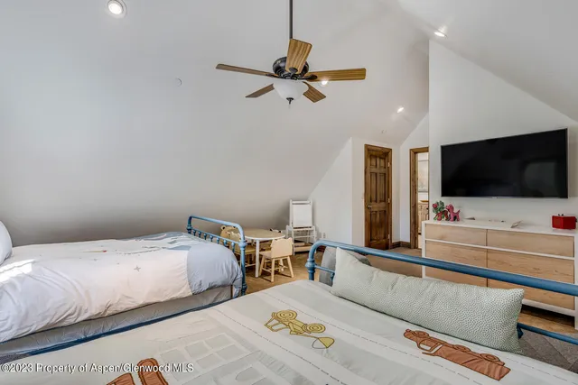 a living room with furniture gym equipment and a rug