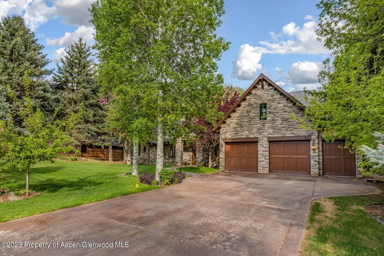70 River Bend Road Snowmass, CO 81654 - Photo 70 of 70 a front view of a house with a yard and garage