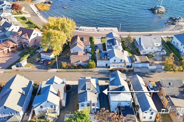 an empty room with windows and ceiling fan