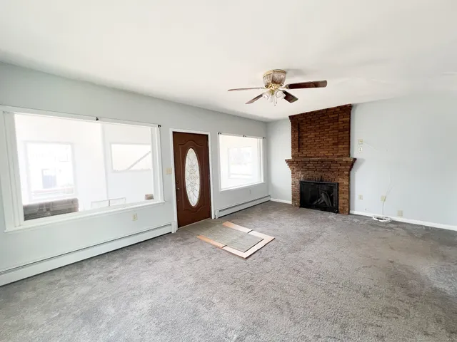 a kitchen with cabinets appliances a sink and a window