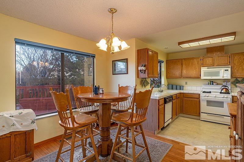5849 Walnut Creek Road Reno, NV 89523 - Photo 1 of 20 a view of a dining room with furniture wooden floor and a chandelier