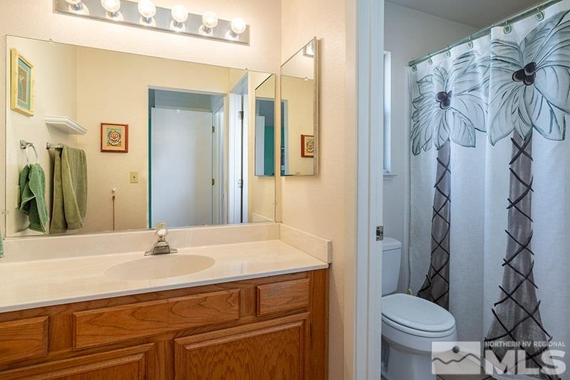 5849 Walnut Creek Road Reno, NV 89523 - Photo 11 of 20 a bathroom with a sink toilet and shower