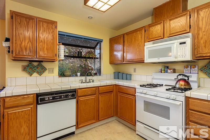 5849 Walnut Creek Road Reno, NV 89523 - Photo 3 of 20 a kitchen with stainless steel appliances granite countertop a stove sink and cabinets