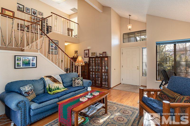 5849 Walnut Creek Road Reno, NV 89523 - Photo 6 of 20 a living room with furniture a flat screen tv and a dining table