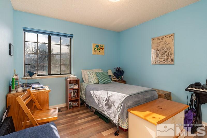 5849 Walnut Creek Road Reno, NV 89523 - Photo 8 of 20 a bed room with a bed and a chair