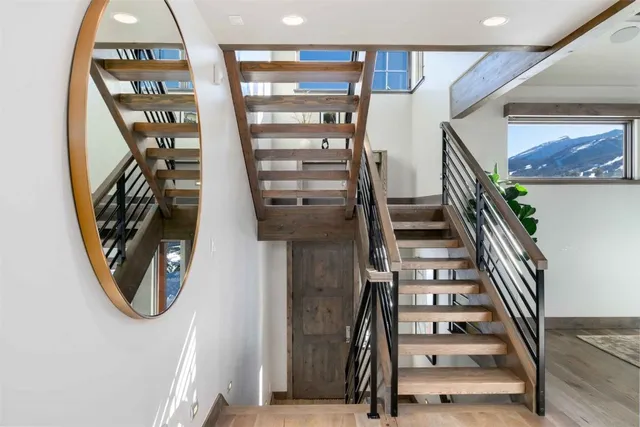 a view of staircase with wooden floor and windows