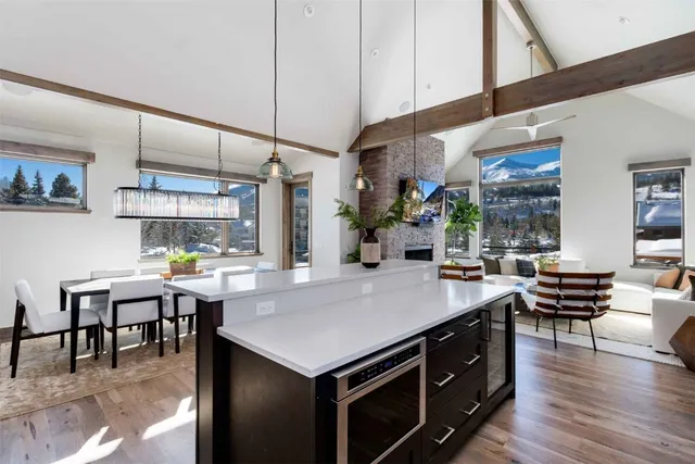 a kitchen with a table chairs and wooden floor