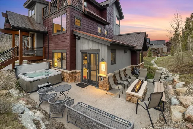 a view of a patio with couches table and chairs and potted plants