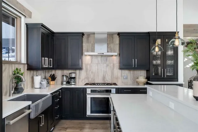 a kitchen with granite countertop a stove and a sink