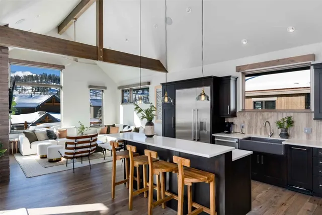 a large kitchen with a table and chairs