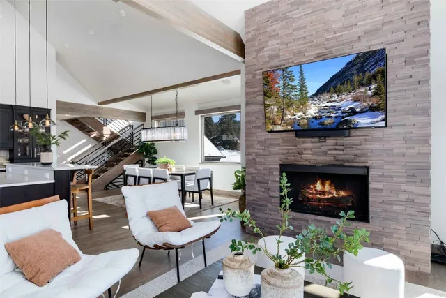 a living room with furniture a fireplace and a flat screen tv