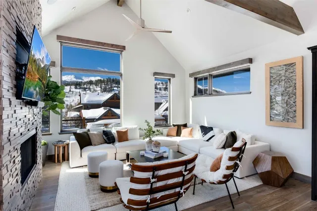 a living room with furniture a rug and a fireplace