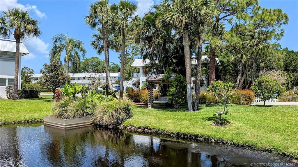 2929 Southeast Ocean Boulevard, Unit L8 Stuart, FL 34996 - Photo 11 of 32 a view of a lake with a building in background