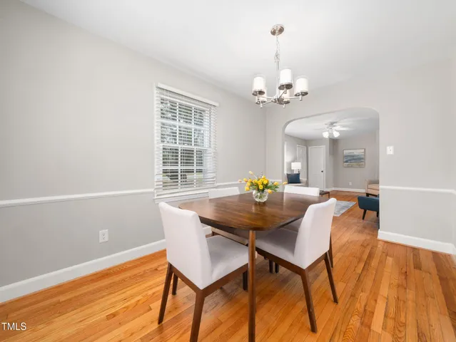 a view of a dining room with furniture and chandelier